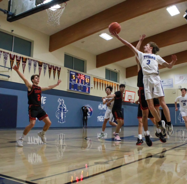 Gage Oelschlager goes up to the basket trying to score the ball
(Photo By: Harper Koeniges).
